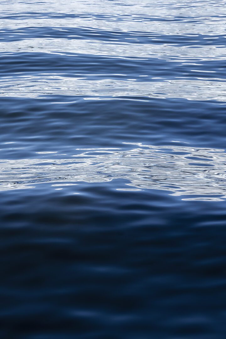 A body of water with white and blue waves.