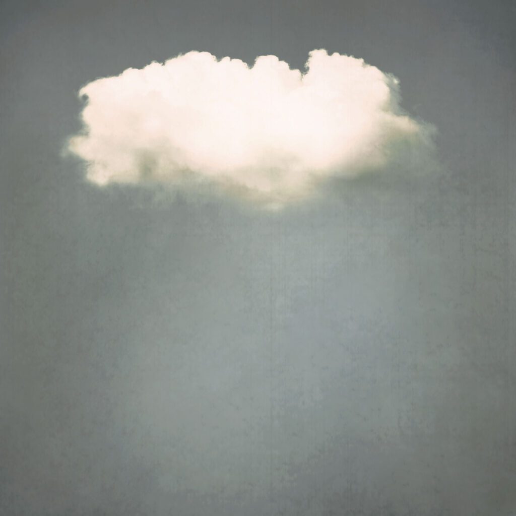 A cloud is shown in the sky with a gray background.